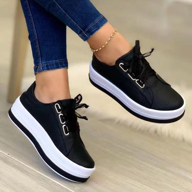AdTec women's black lace-up platform sneakers with a white chunky sole and round toe.