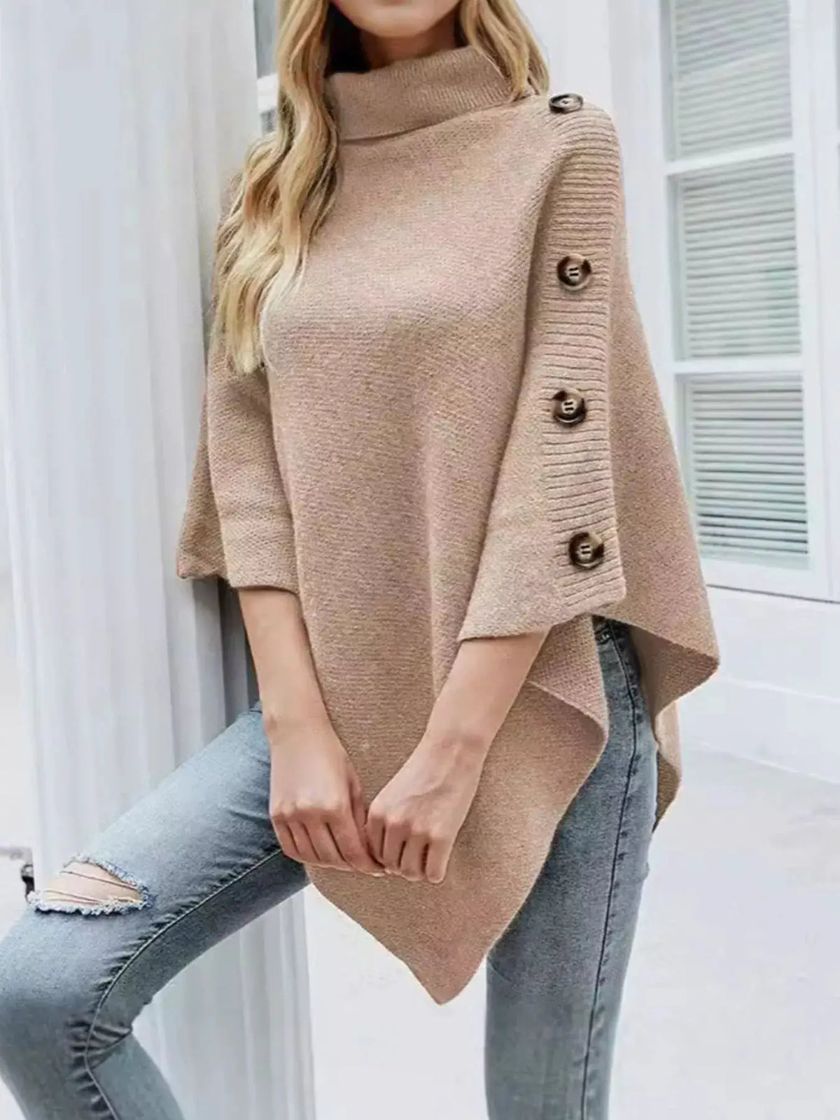 Button turtleneck poncho pullover in tan knit with buttoned sleeve detail
