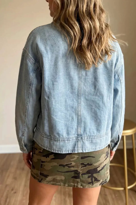 Classic light-wash denim jacket with adjustable drawcord hem, shown with camouflage mini skirt (2 pieces total)