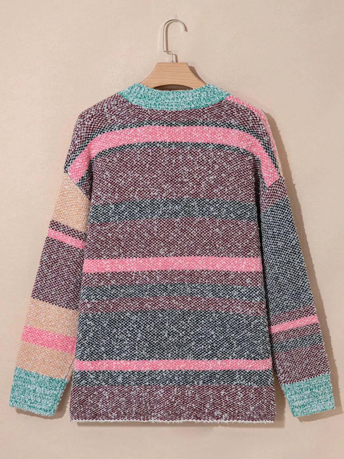Trendsi multi-color striped cardigan sweater, back view on hanger with pink, teal and peach knit stripes