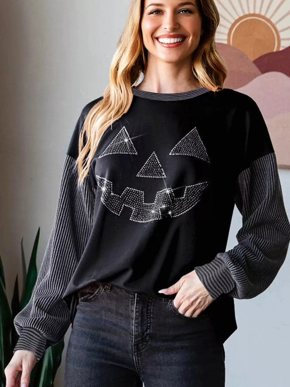 Halloween rhinestone pumpkin-face long-sleeve top in black with striped contrast sleeves