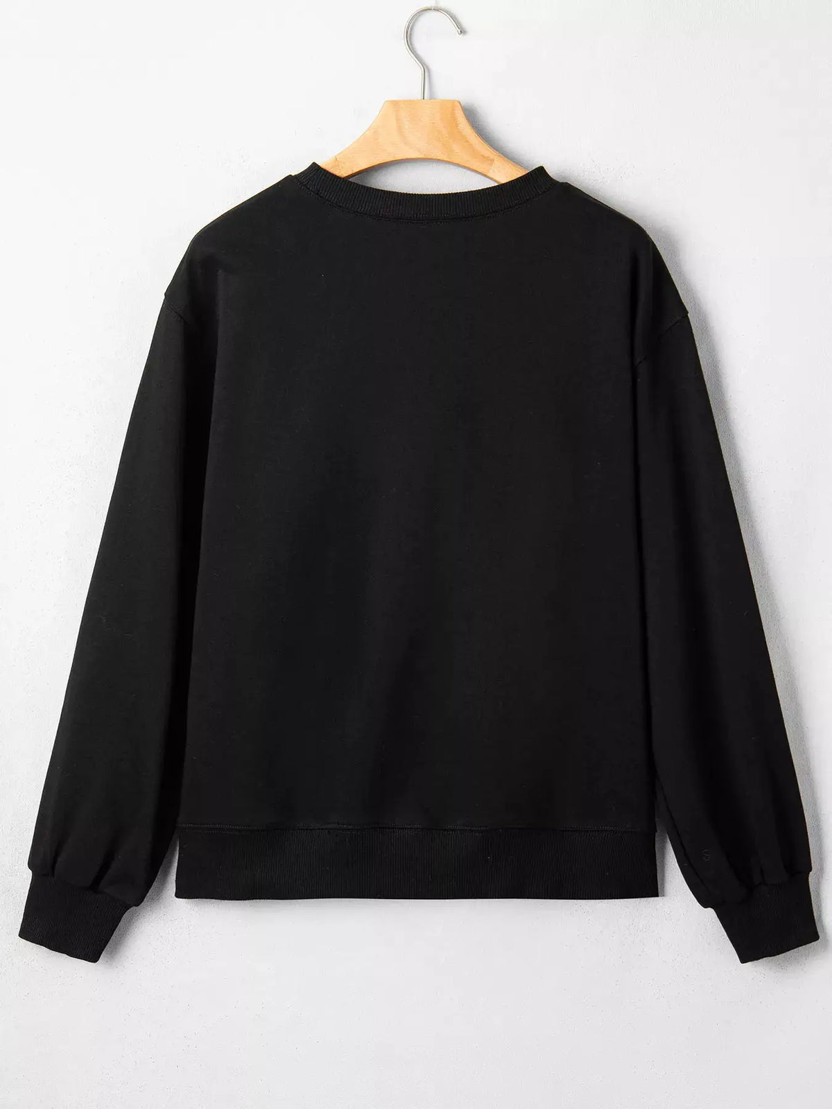Embroidered Spooky Season long-sleeve round-neck sweatshirt in black by Trendsi on a hanger
