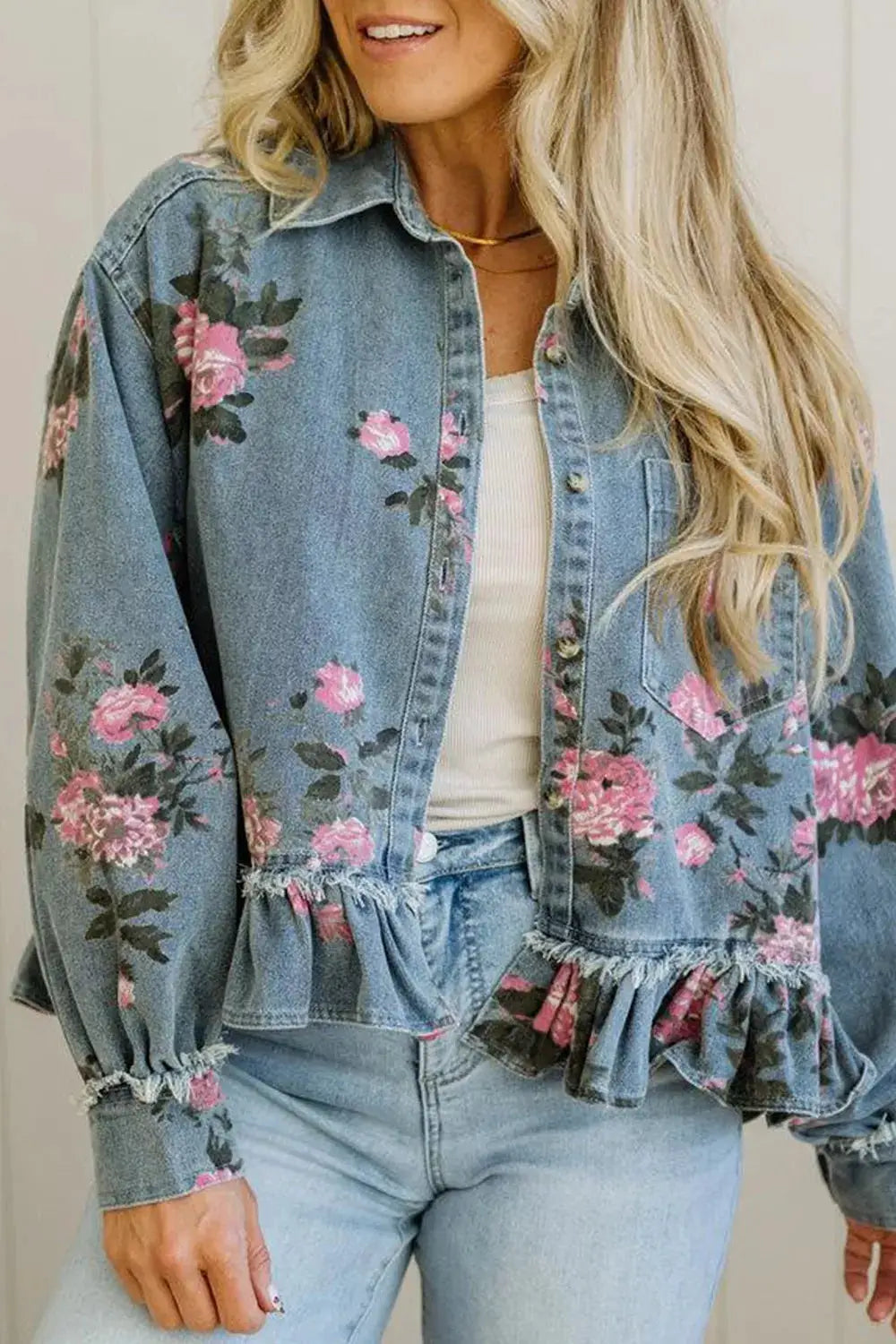 Women floral print denim jacket with delicate ruffled hem in blue wash; long sleeves and front button placket.