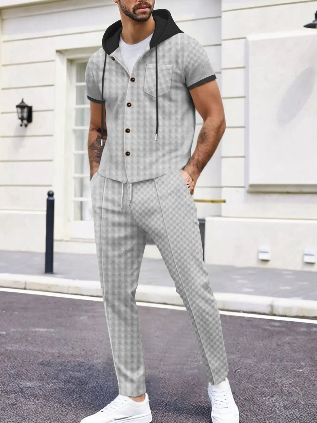 Men's plus-size short-sleeve hooded top and shorts set in light gray textured fabric with pockets.