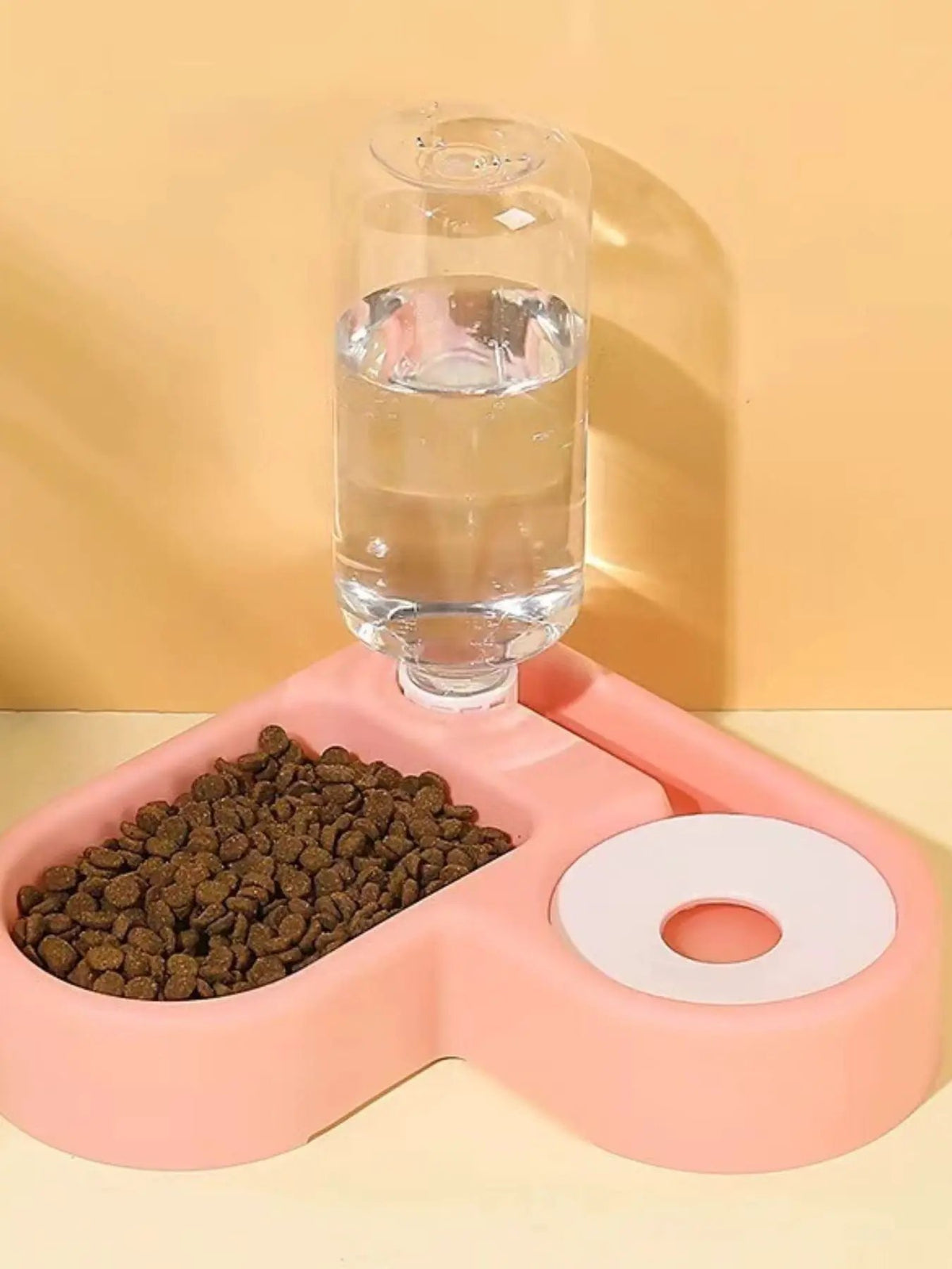 Trendsi pink automatic water-refilling pet bowl with built-in kibble tray and water bottle.