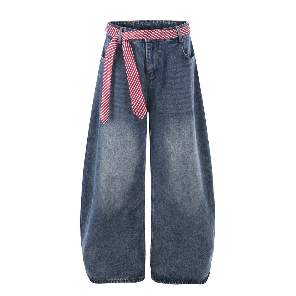 Wide-leg jeans by eprolo in blue denim with red striped belt, street fashion style.