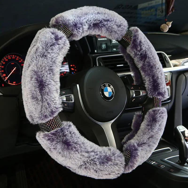Steering wheel cover for car; plush purple fur on BMW wheel with diamond accents.