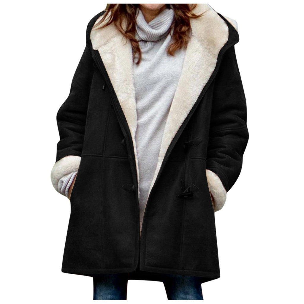 Women's vintage winter coat in black with cream shearling lining.