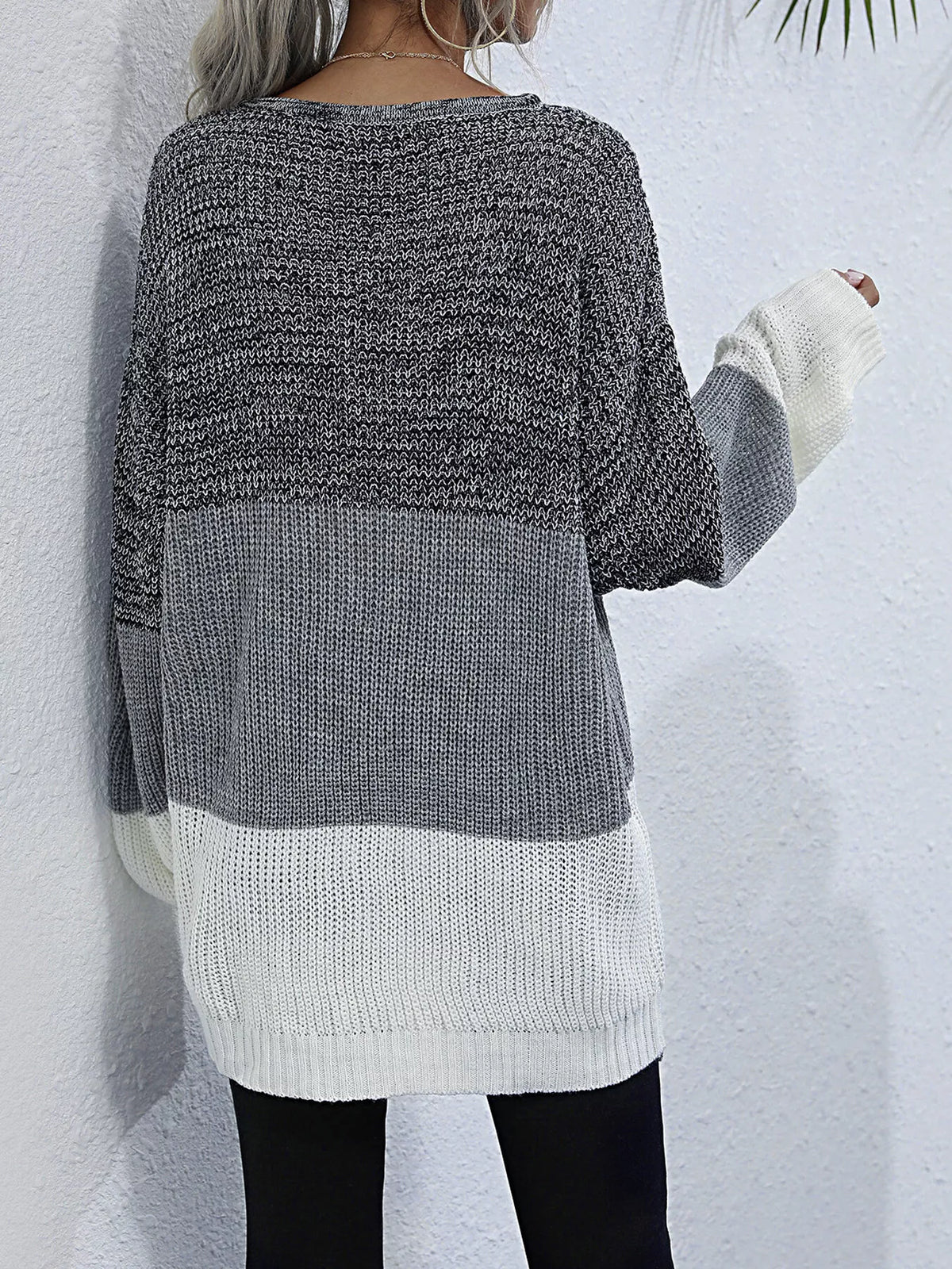 Color-block oversized knit sweater; black, grey and white knit with ribbed hem, back view