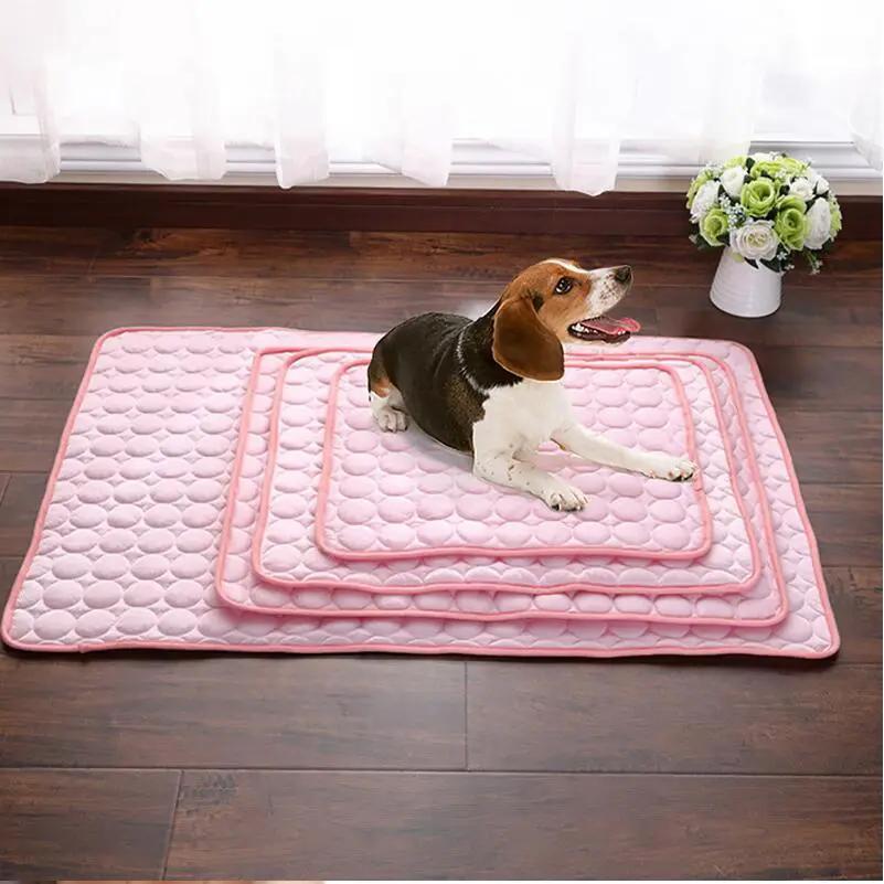 Pet ice silk cooling nest pad set in pink, three nested mats with a dog lying on top.