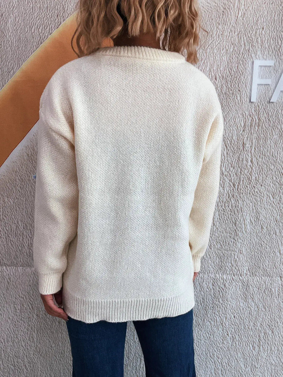 Cream knit pullover sweater for women, round neck, ribbed cuffs and hem, back view