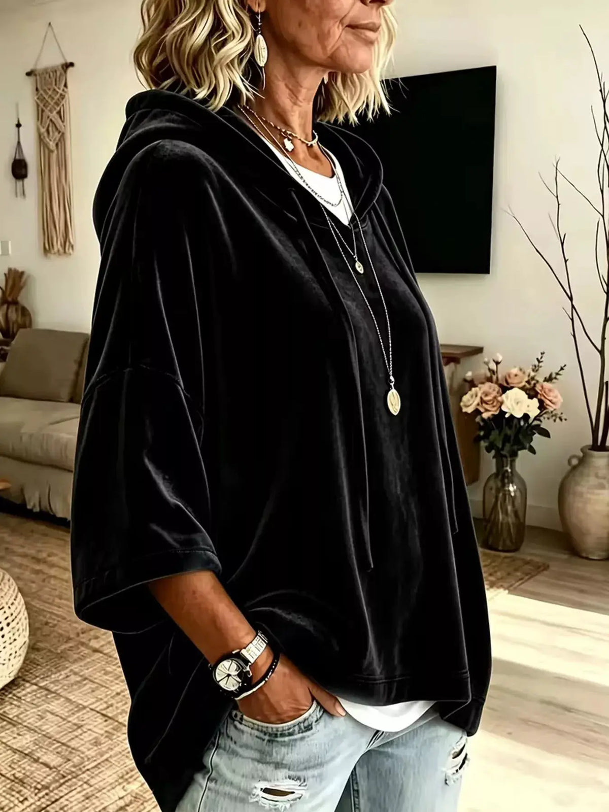 Velvet loose-fit black hoodie with drawstring, worn over a white tee.