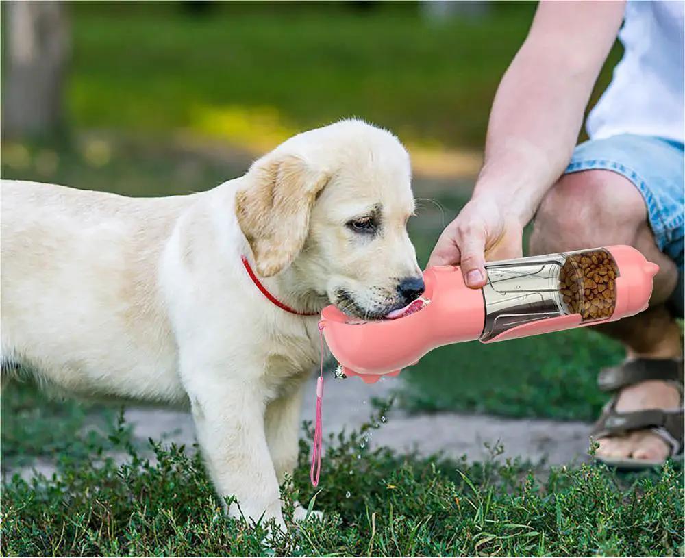 Pet water bottle feeder by AdTec in pink with garbage bag storage for outdoor travel