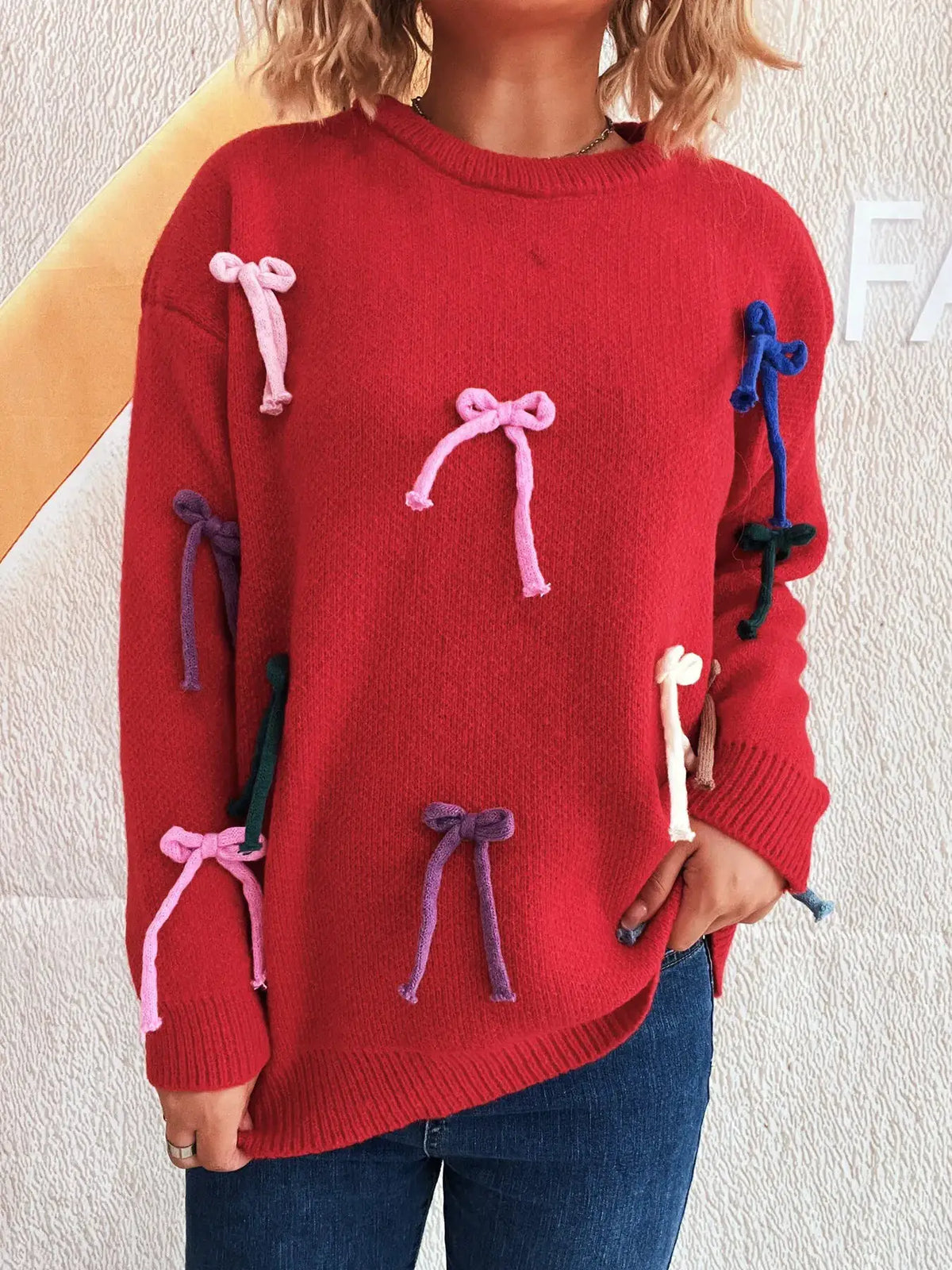 Bow-accent red round-neck sweater with multicolor knitted bows on sleeves and front