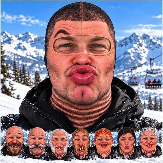 Realistic winter ski face mask balaclava in skin-tone with eye and mouth openings worn by man against snowy mountains.