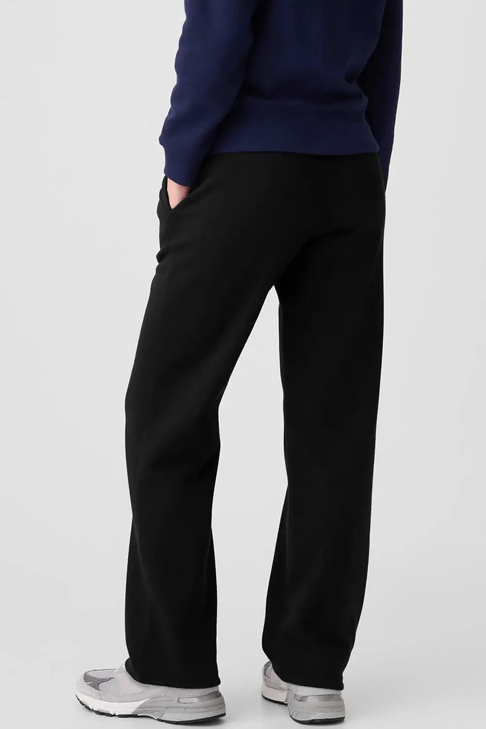 Drawstring pants with pockets, black joggers; shown with a blue top and white sneakers.