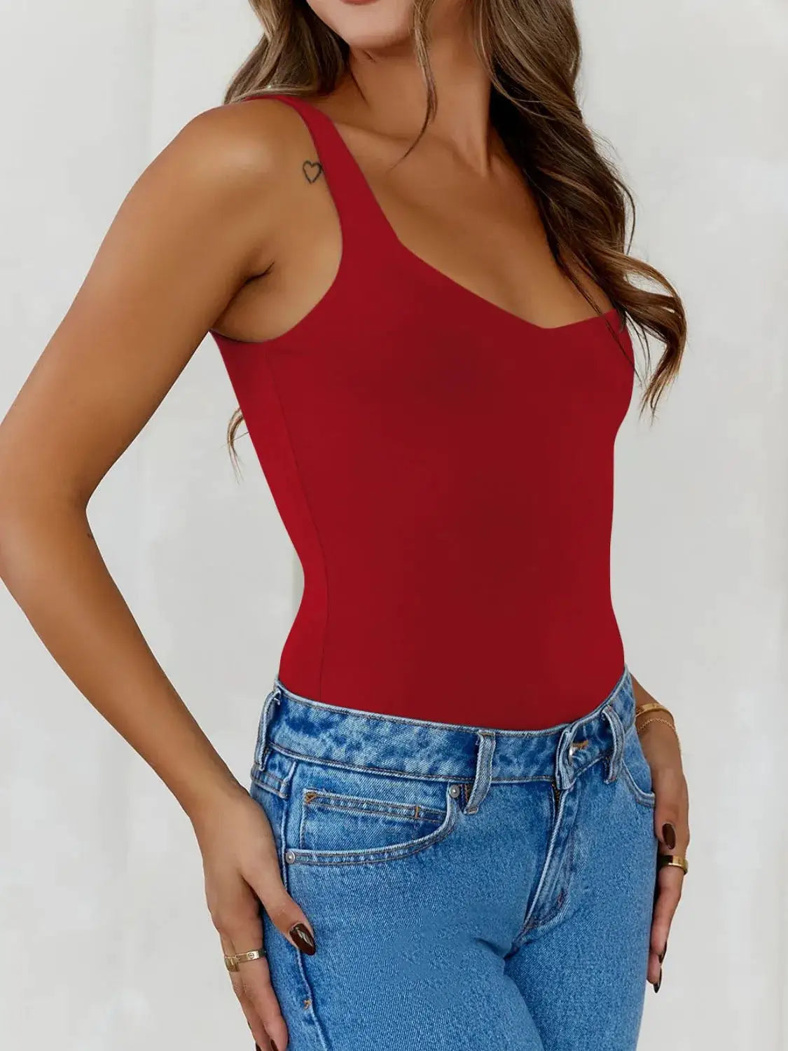 Solid red wide-strap cami top by Trendsi, shown on model with blue jeans