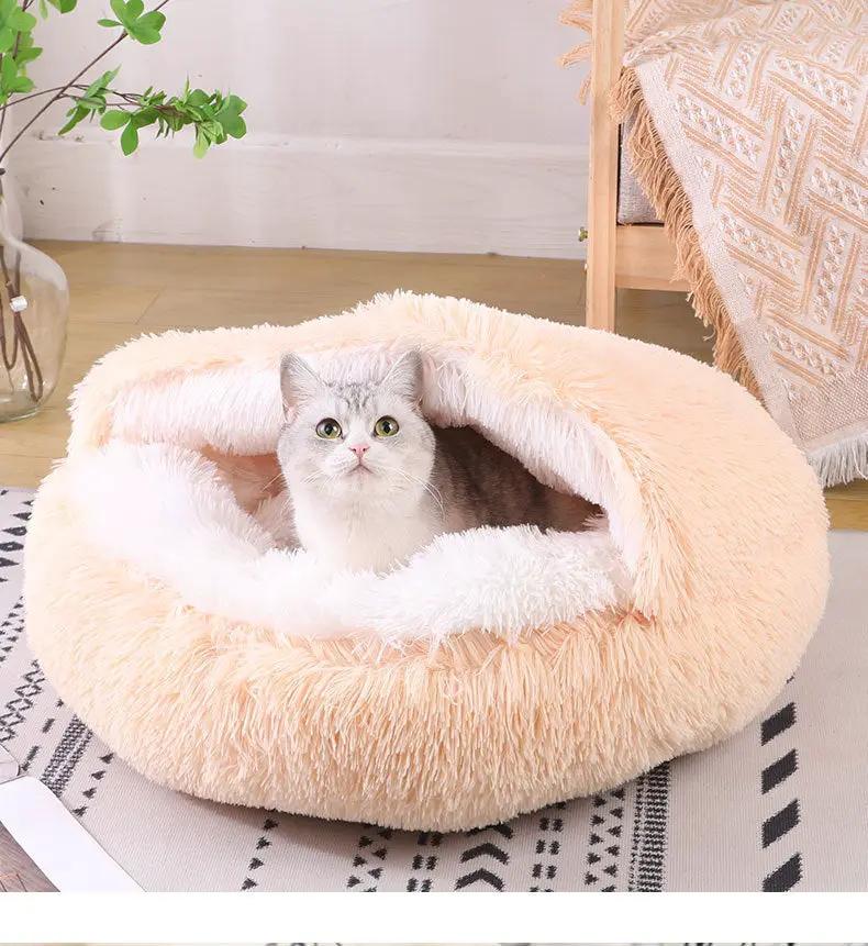 Deep Sleep plush donut pet bed by AdTec, peach with white fluffy inner rim, semi-enclosed round bed with a cat inside.