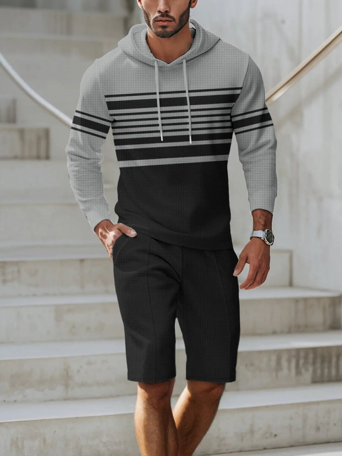 Men's striped hoodie and shorts loungewear set in gray and black with a drawstring hoodie