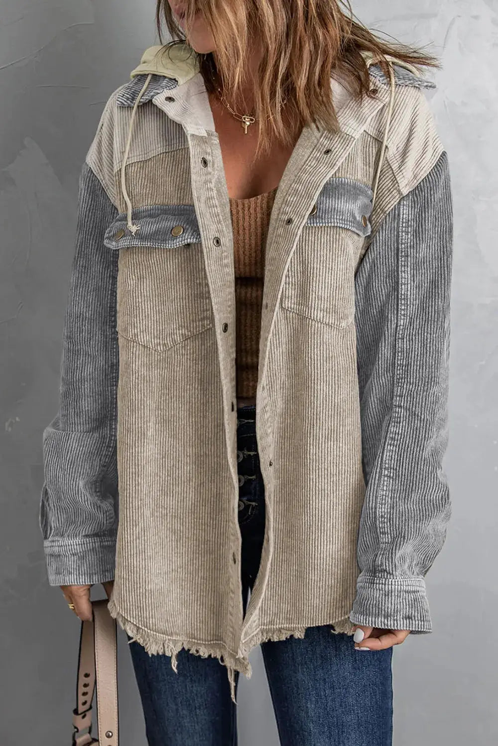 Snap-front hooded corduroy shacket by Trendsi; beige torso with gray sleeves, frayed hem