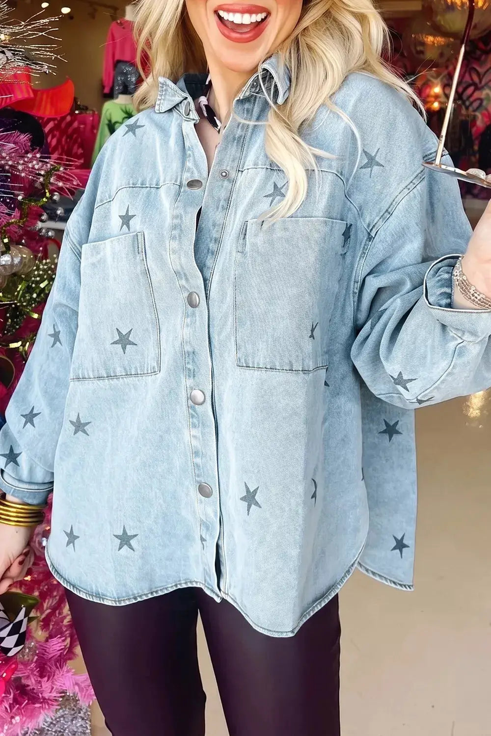 Light-wash star-print denim jacket with front pockets and snap buttons, oversized casual outerwear.