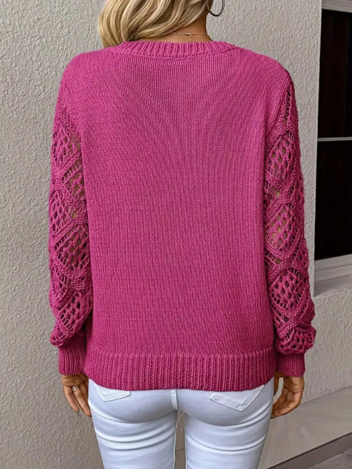 Womens pink V-neck knit sweater with hollow-out lattice sleeves and ribbed hem, back view