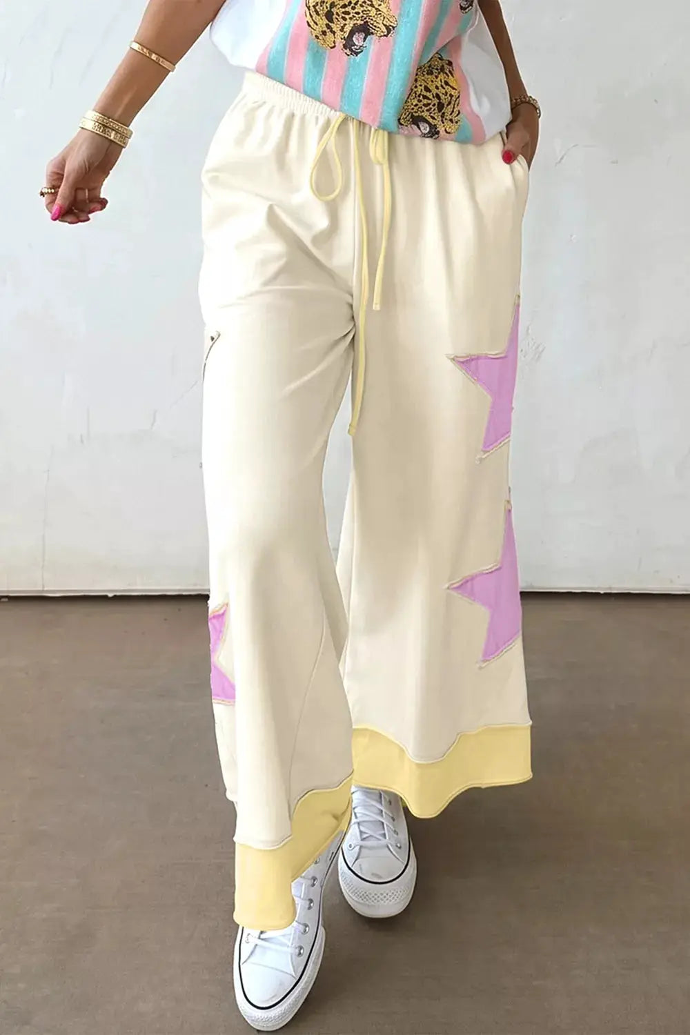 Star Patch Wide Leg Palazzo Pants in cream with pink star patches and yellow hem.