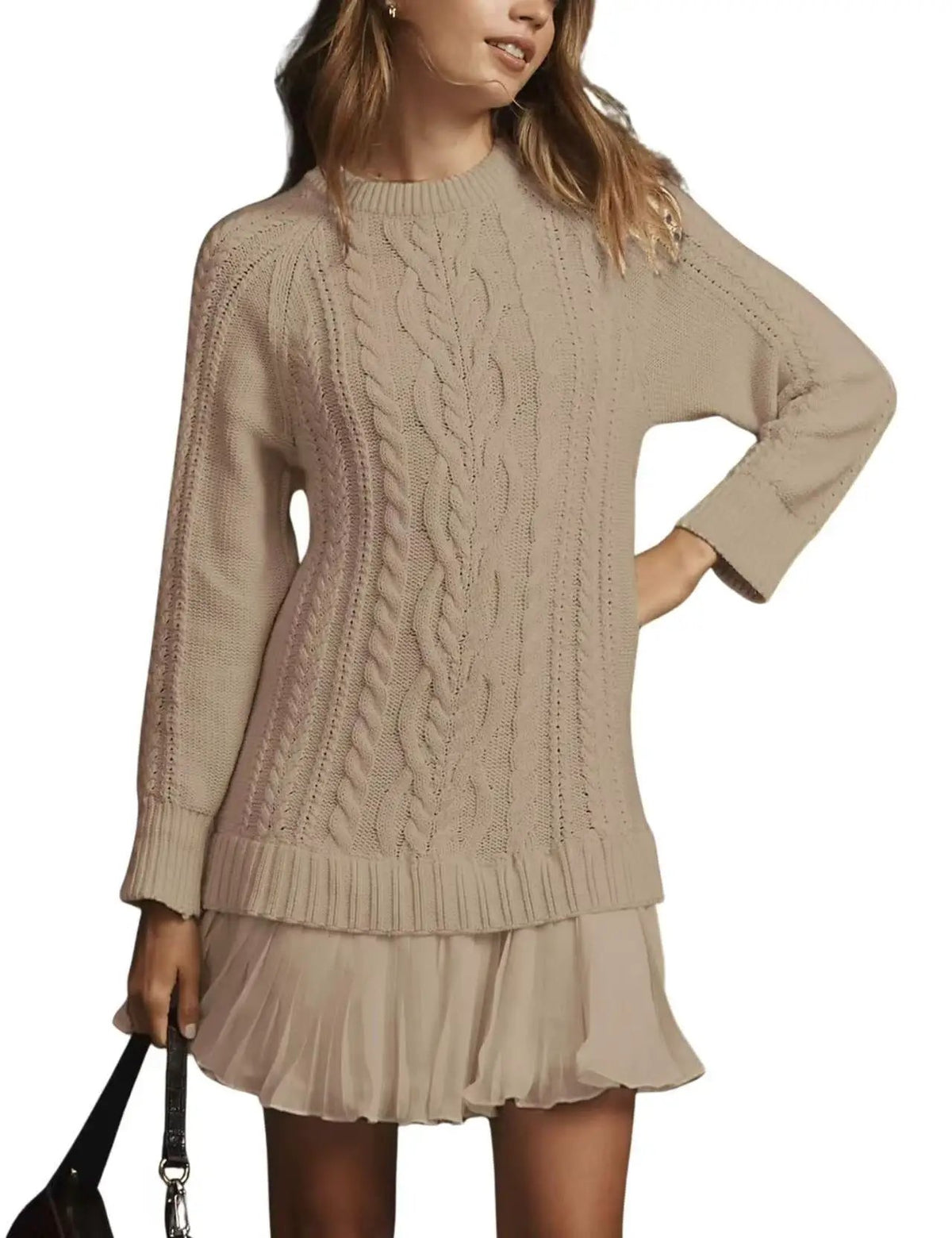 Women beige cable-knit sweater, relaxed fit with ribbed hem and cuffs, paired with a pleated skirt.