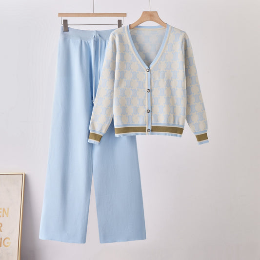 Two-piece knit set: light-blue cardigan with pale check pattern, brown trim, and matching wide-leg pants.