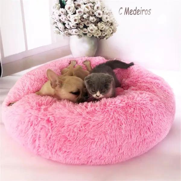 Round pink plush cat nest bed with two kittens resting in it