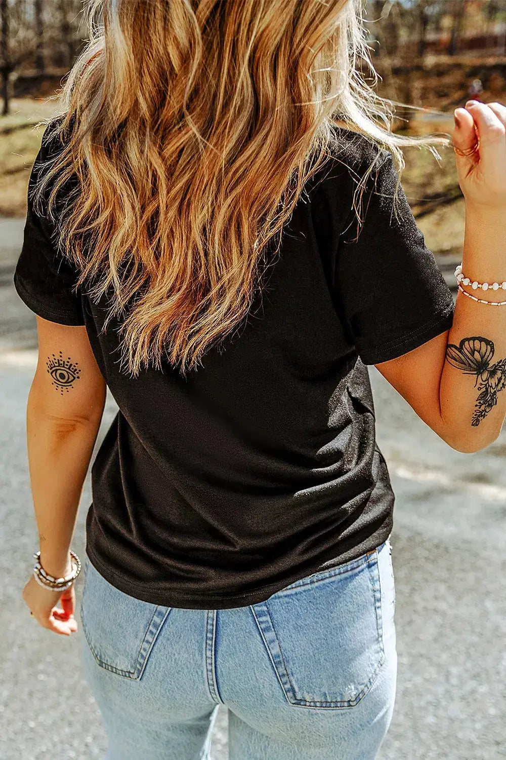 Trendsi Rhinestone Skull Graphic Crew Neck T Shirt, black, back view on model with jeans