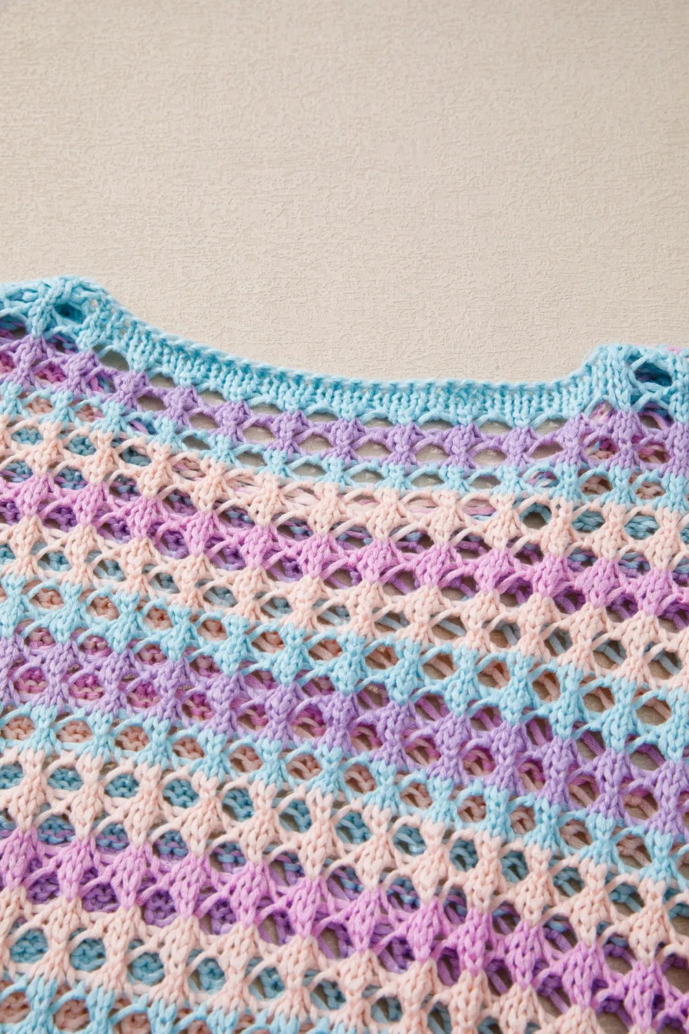 Striped openwork crochet cover-up in pastel blue, pink, and lavender