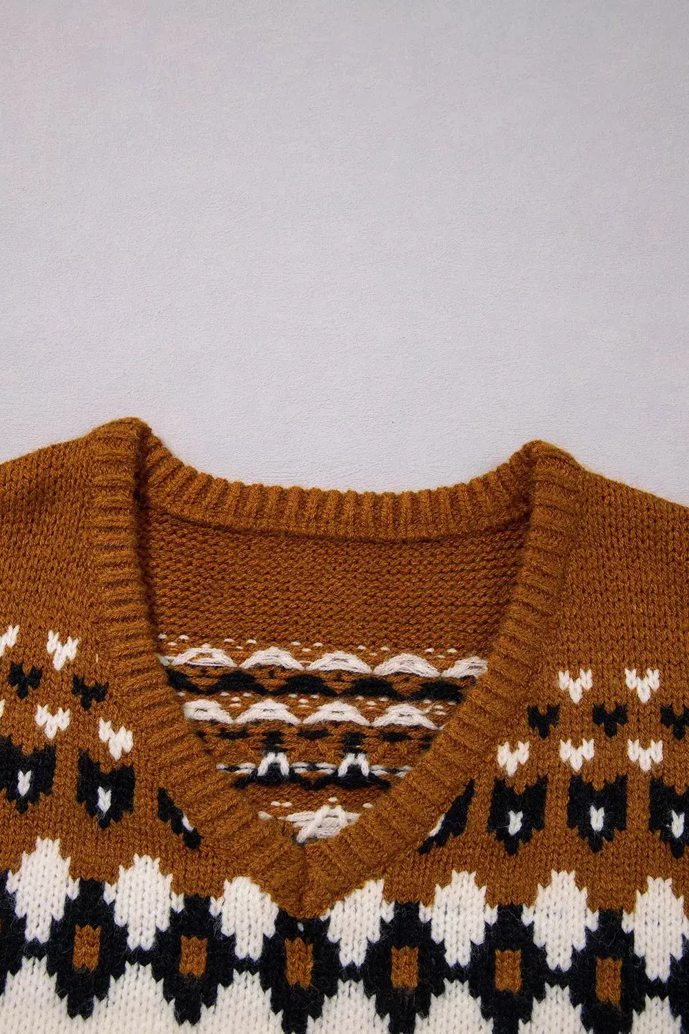 V-neck Short Sleeve Geometric Sweater in rust knit with white and black geometric pattern