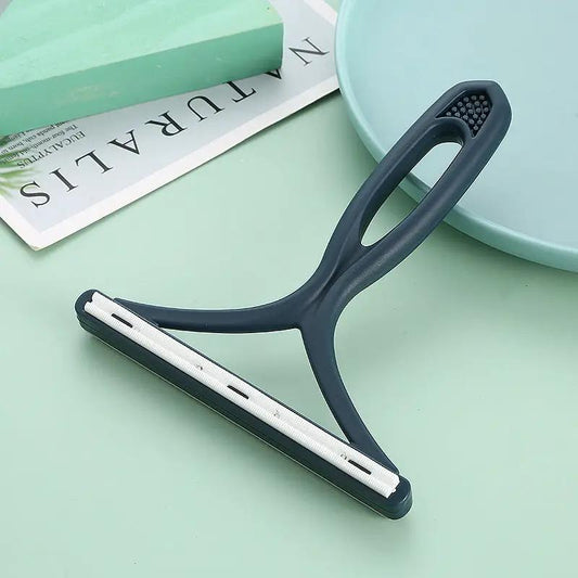 Blue silicone double-sided pet hair remover tool with white fabric-scraper blade for clothes and carpet