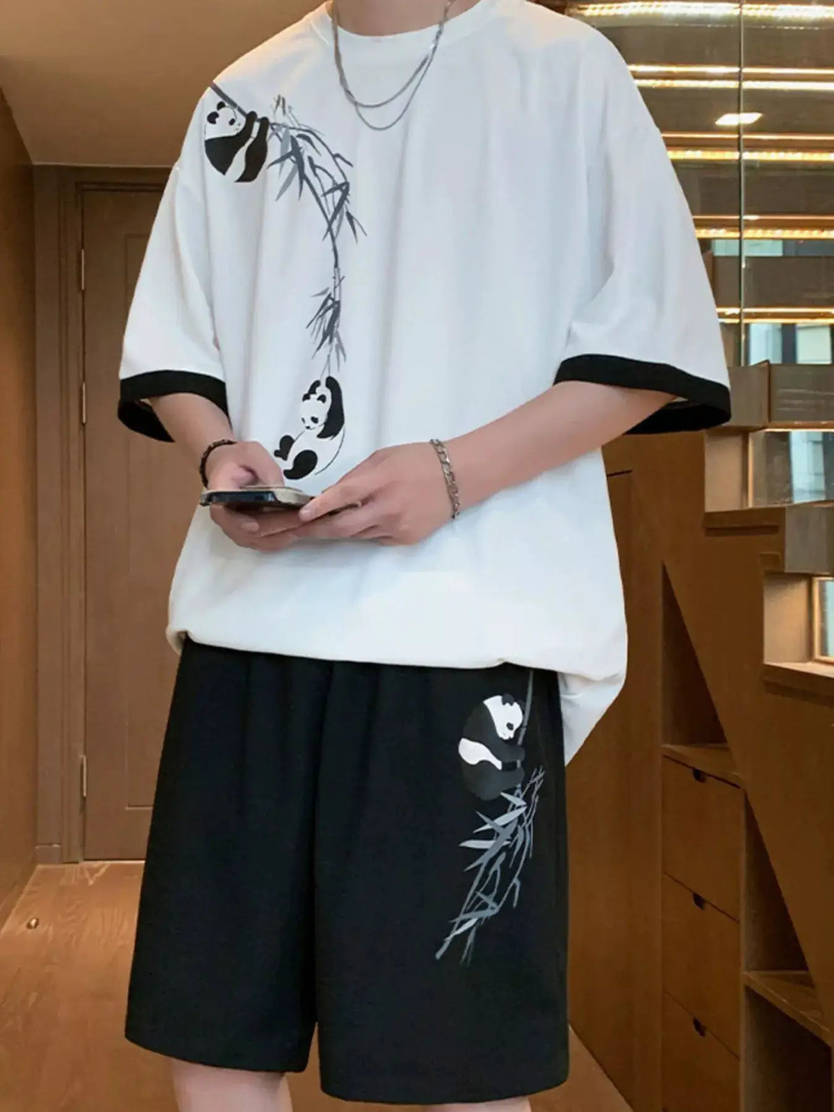 Men's oversized panda bamboo print 2-piece set: white tee with bamboo panda motif and black shorts with panda graphic