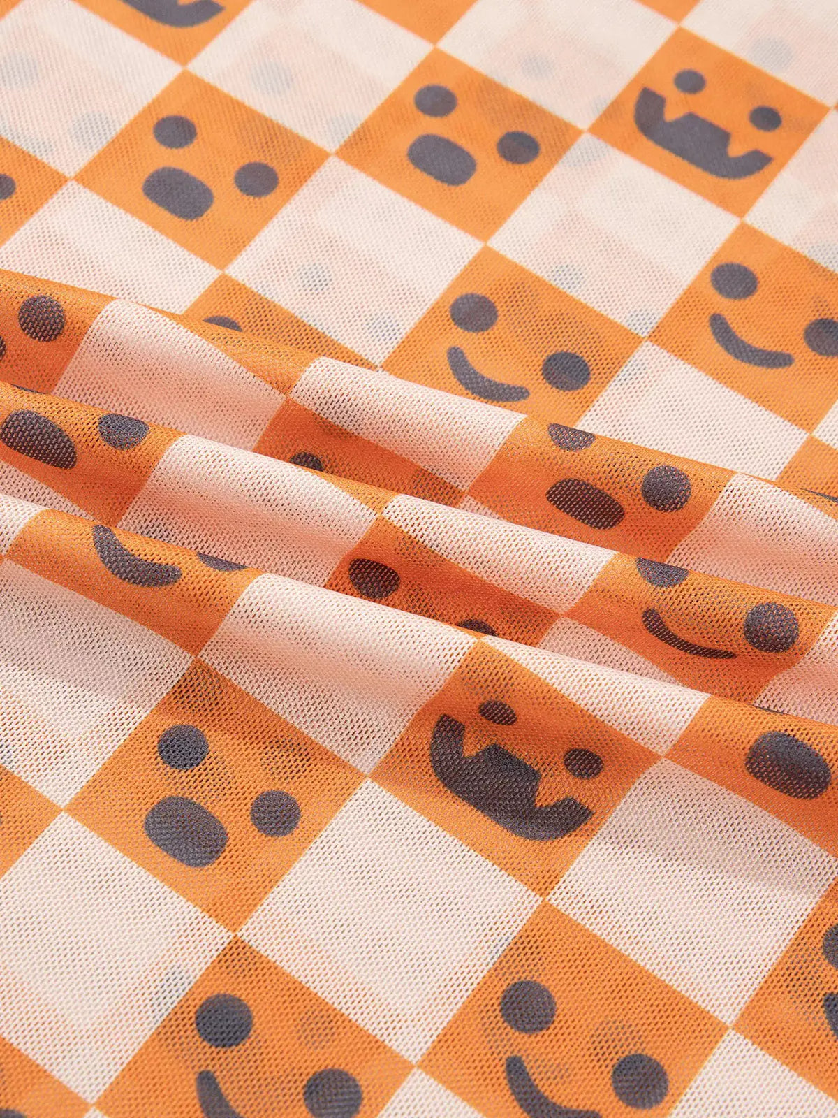 Abstract Halloween Pattern Long Sleeve Mock Neck Blouse in orange and white checkered pattern with gray smiley accents