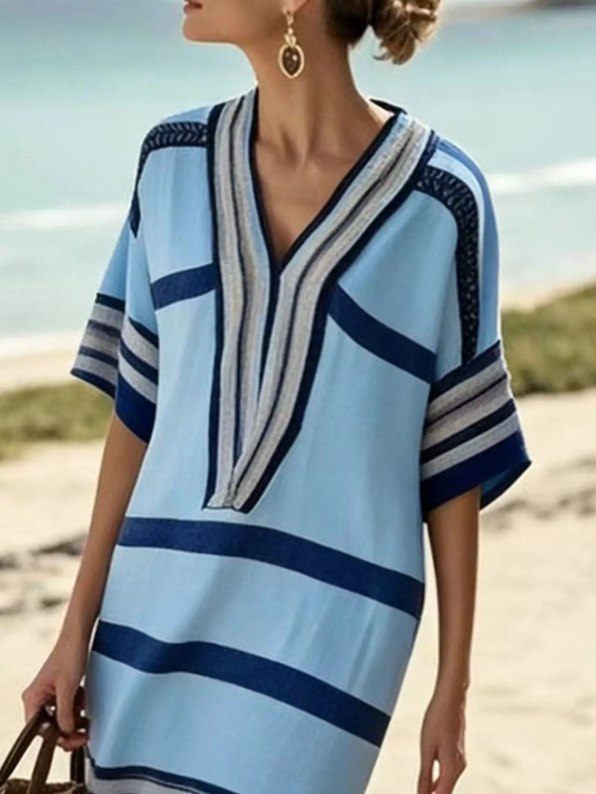 Plus-size striped midi dress with half sleeves and wrap neckline in light blue and navy.