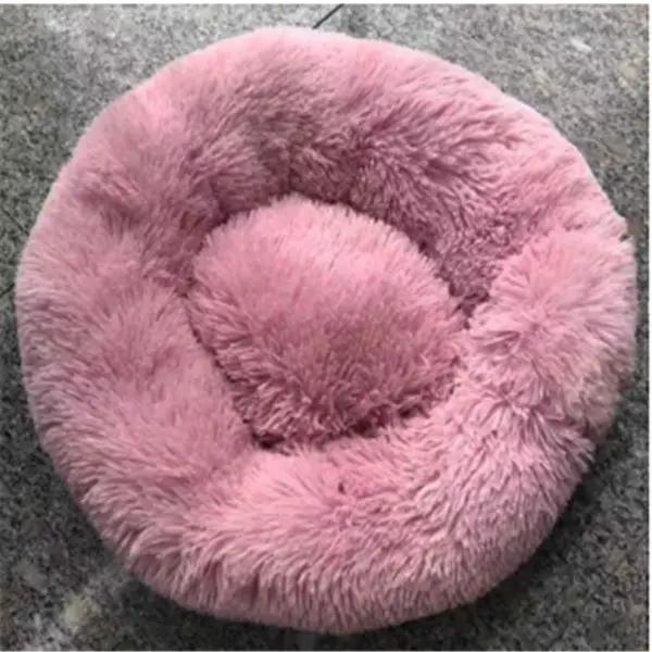 Round pink plush cat nest bed with long fur, a cozy autumn and winter cat mattress.