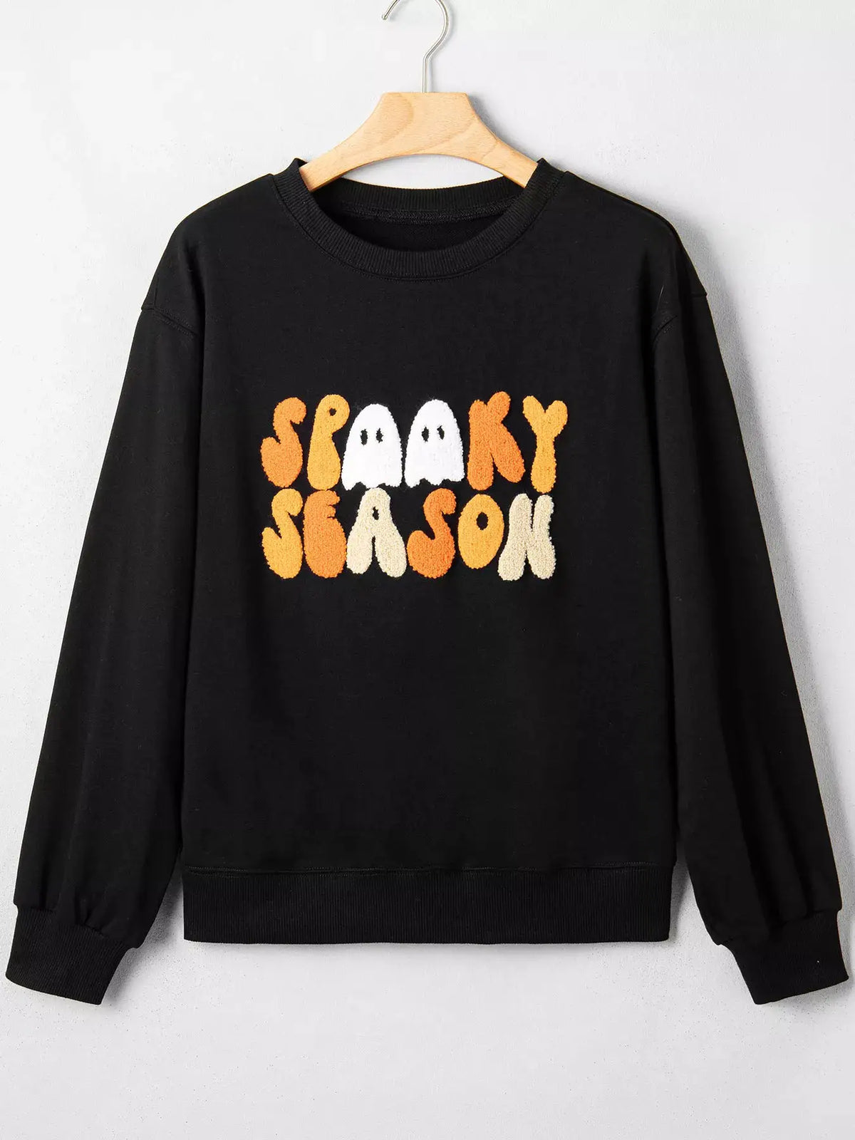 Embroidered Spooky Season long sleeve black sweatshirt with orange and white fuzzy lettering