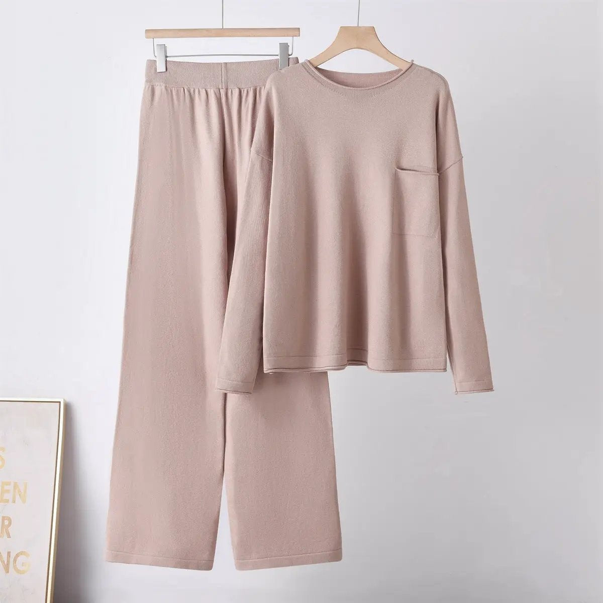 Women's pink knit two-piece set with oversized sweater featuring a pocket and wide-leg pants