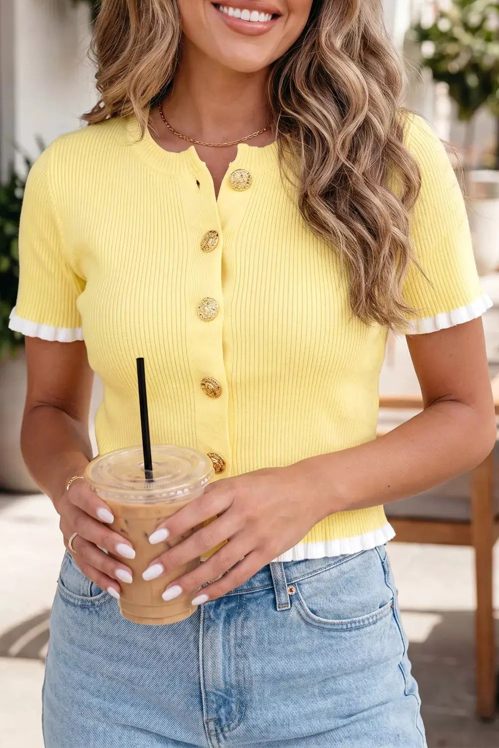 Short sleeve ribbed knit cardigan in yellow with white frill-edged sleeves and gold buttons