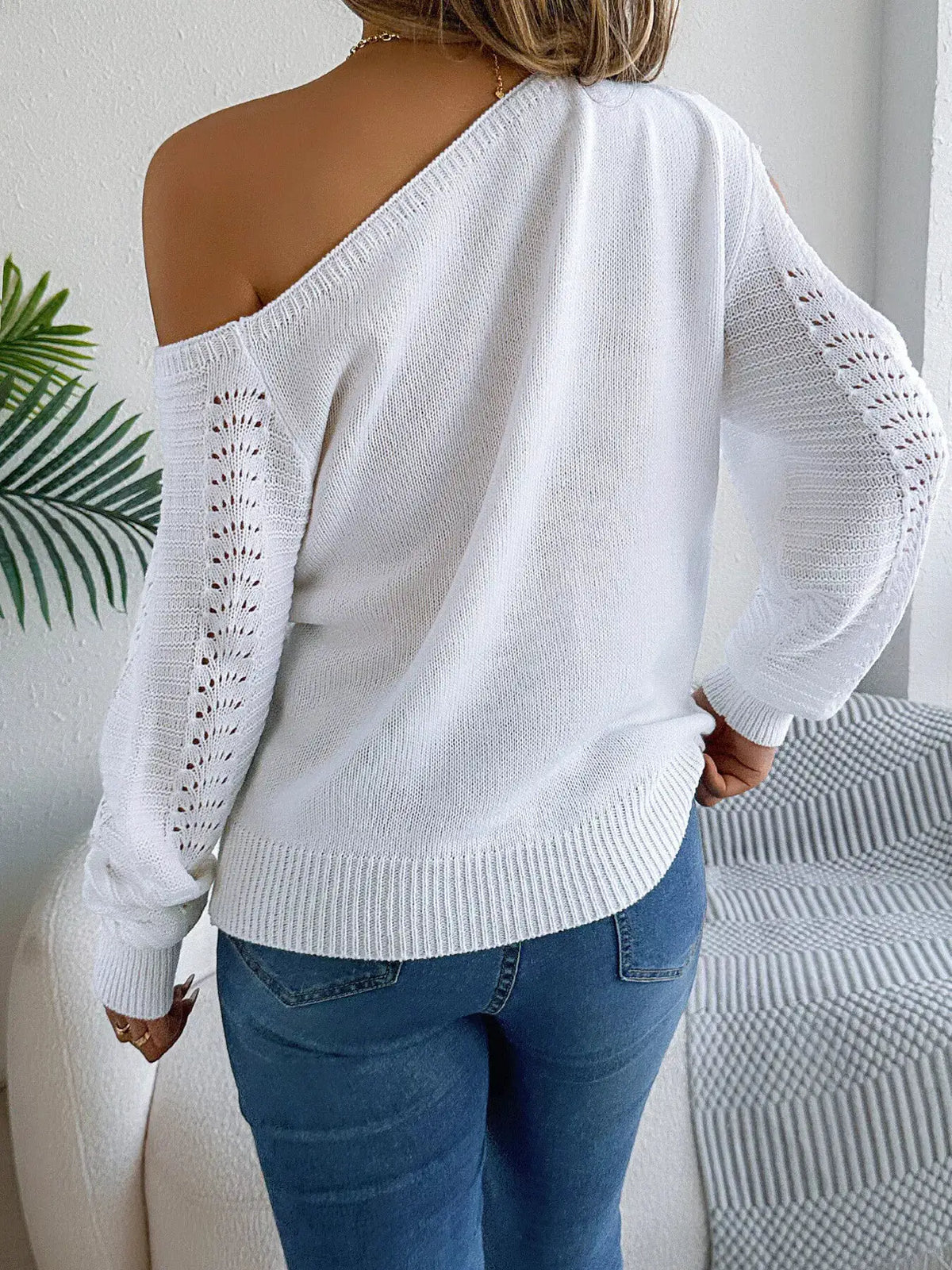 Openwork one-shoulder knit sweater in white with long sleeves and cutout detailing