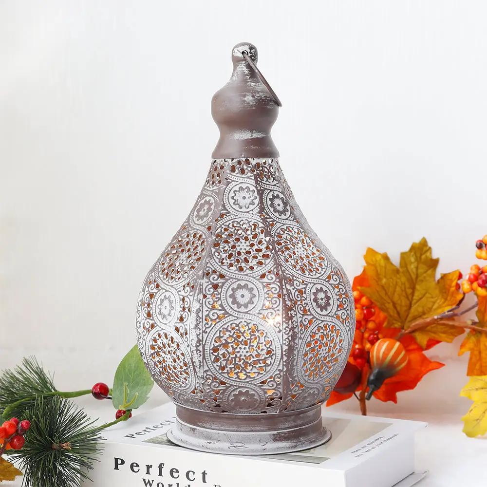 11.5-inch tall battery-powered table lamp by JHY DESIGN; distressed gray metal with ornate perforated pattern