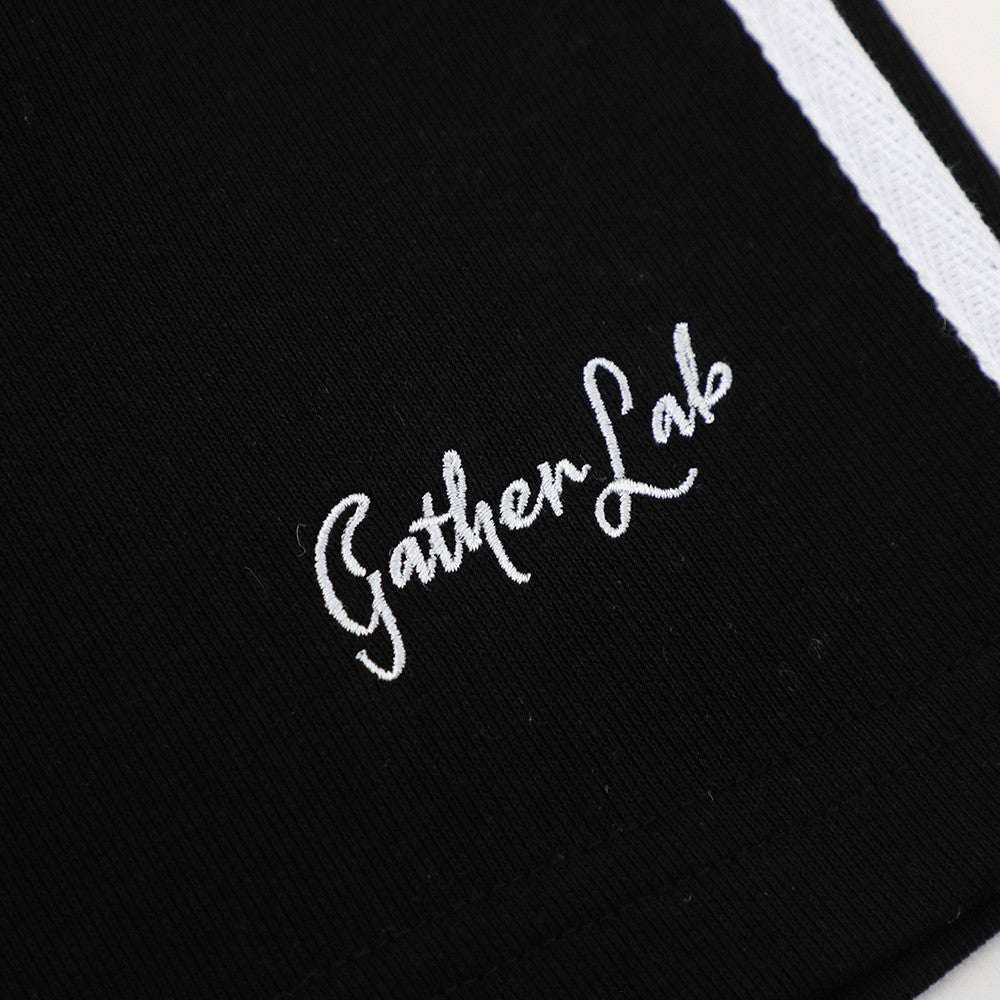 Hand drawn letter printed jogger shorts in black with white script embroidery