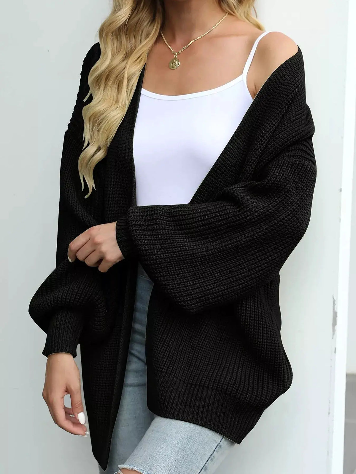 Cozy oversized black chunky knit cardigan with lantern sleeves and open front