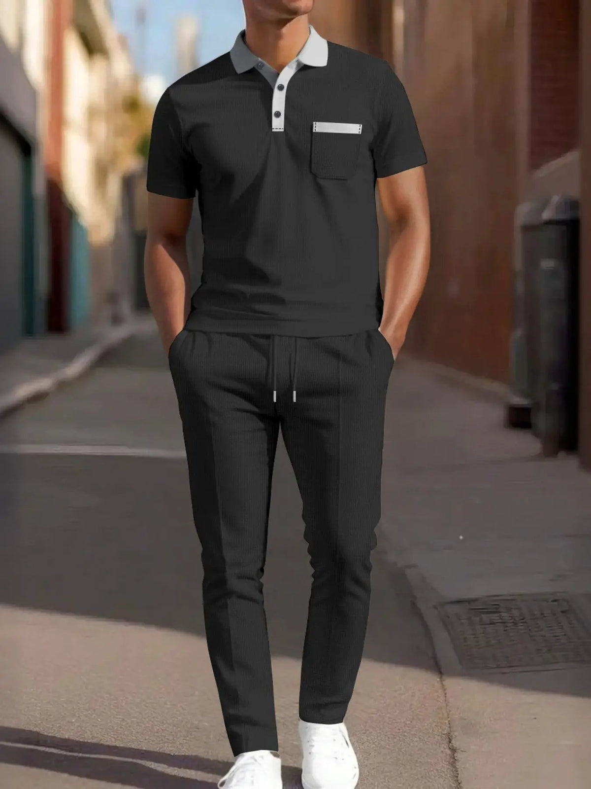 Men's matching short-sleeve polo and pants set, black with white collar trim and pocket accent, Trendsi.