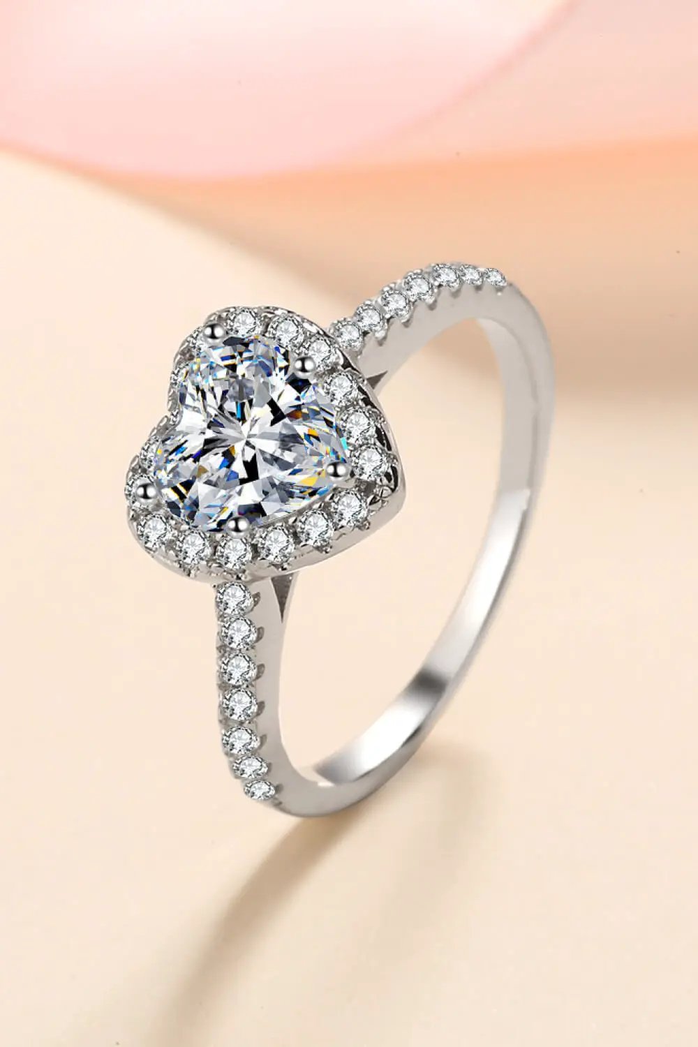 Moissanite heart-shaped 1 carat engagement ring by Trendsi with diamond halo, white gold band.