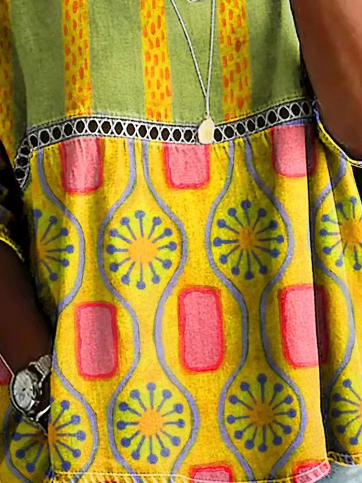 Full Size Hollow Out Round Neck Top Plus Size, bright yellow with pink panels and blue circular motifs.