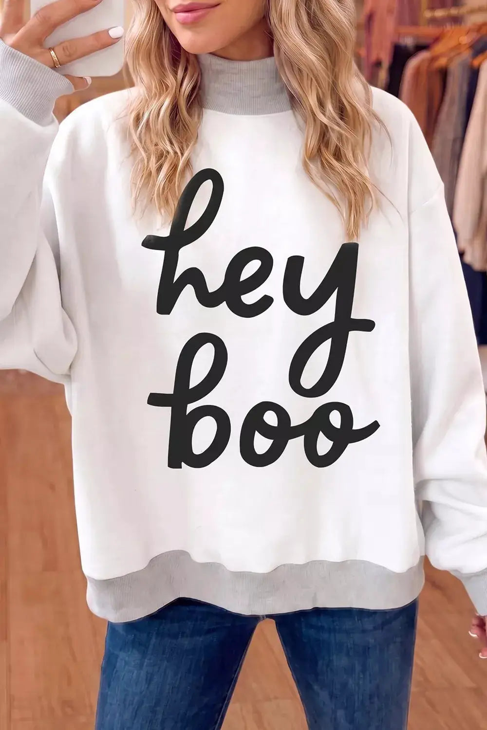 White reversible Halloween graphic mock-neck tunic sweatshirt with gray cuffs and hem, bold black hey boo lettering