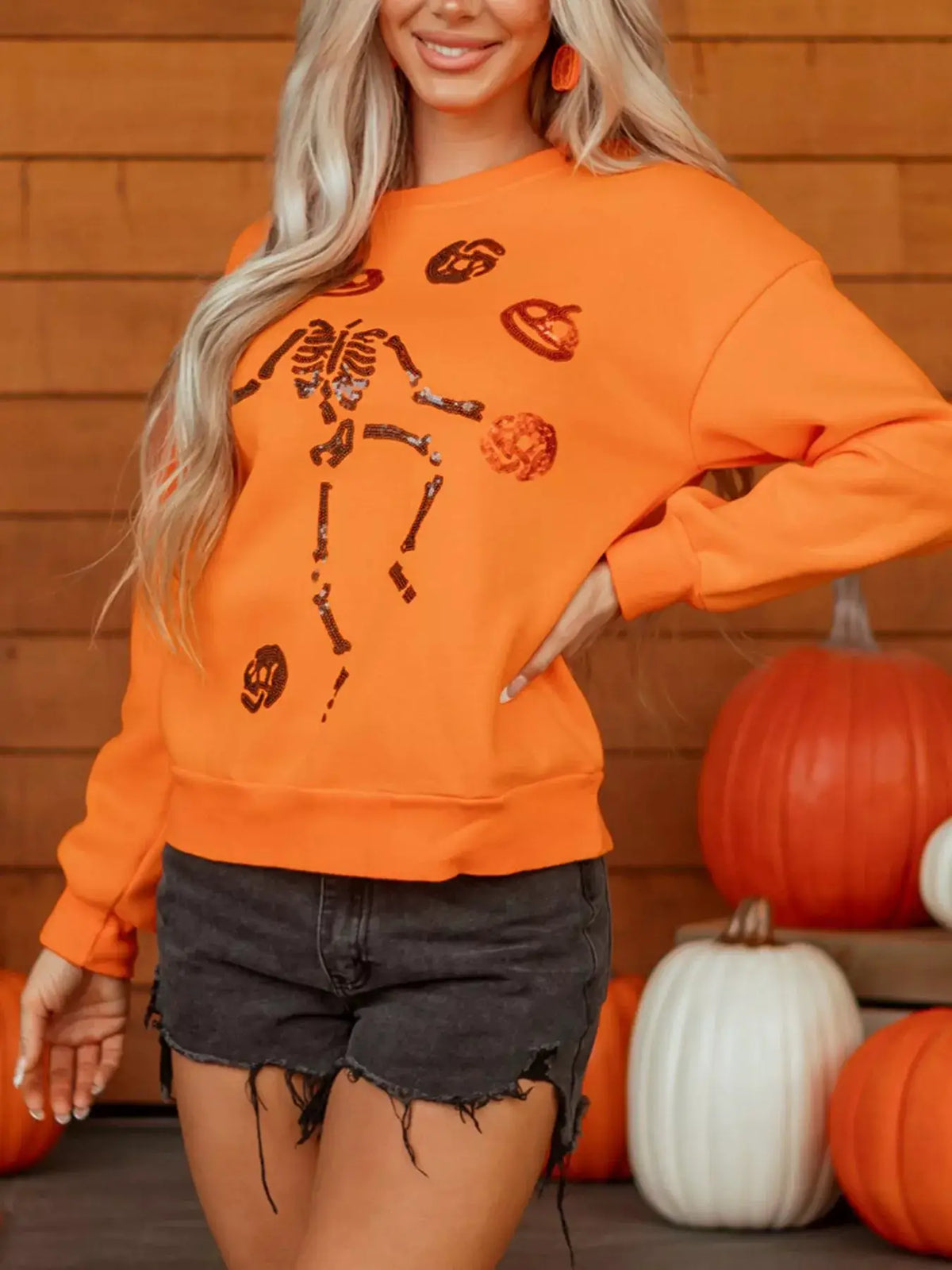 Dancing Critters Sequin Halloween Crewneck Sweatshirt in orange with black sequin skeleton motifs
